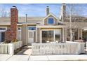 A home with a well-maintained front yard, a chimney, and a cozy patio area at 162 Blue Spruce Ct, Highlands Ranch, CO 80126