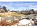 Outdoor patio with seating area overlooks a green lawn and trees, perfect for relaxation at 162 Blue Spruce Ct, Highlands Ranch, CO 80126