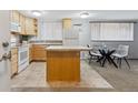 Bright kitchen with light wood cabinets and tile flooring, adjacent to dining area at 1260 N Humboldt St # 1, Denver, CO 80218