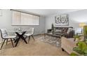 Cozy living room with grey couch, modern decor, and ample natural light from window at 1260 N Humboldt St # 1, Denver, CO 80218