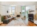 Spacious living room features a fireplace, vaulted ceilings, and wood flooring at 14121 E Baltic Pl, Aurora, CO 80014