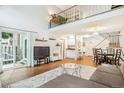 Open concept living area with hardwood floors and slider to patio at 14121 E Baltic Pl, Aurora, CO 80014