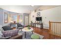 Inviting living room with large windows, hardwood flooring, and cozy seating at 2517 E Egbert St, Brighton, CO 80601