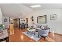 Bright living room featuring hardwood floors, skylights, and modern decor at 2517 E Egbert St, Brighton, CO 80601