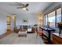 Well-lit living room featuring a brown leather couch, a workspace, and wood floors throughout the room at 1105 Bacchus Dr # F8, Lafayette, CO 80026