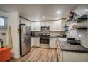 Well-equipped kitchen featuring stainless steel appliances, white cabinets, and ample counter space at 1842 Canyon Blvd # 105, Boulder, CO 80302