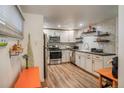 Updated kitchen features stainless steel appliances, white cabinets, and sleek countertops at 1842 Canyon Blvd # 105, Boulder, CO 80302