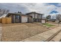 Contemporary two-story home with minimalist rock landscaping and attached garage at 12932 E Elgin Pl, Denver, CO 80239