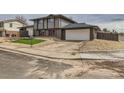 Two-story home with an attached garage, green lawn detail and minimalist rock landscape at 12932 E Elgin Pl, Denver, CO 80239