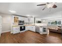 Bright and airy kitchen with white cabinetry, stainless steel appliances, and hardwood floors at 3395 W Union Ave, Englewood, CO 80110