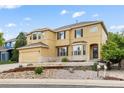 Inviting two-story home featuring a two-car garage, stone accents, bay windows, and a landscaped front yard at 13262 Elizabeth St, Thornton, CO 80241