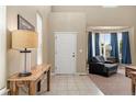 Bright foyer showcasing high ceilings, tile floors, and a view into the cozy living room at 13262 Elizabeth St, Thornton, CO 80241