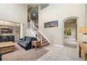 Spacious living room with high ceilings, grand staircase, and access to other living spaces at 13262 Elizabeth St, Thornton, CO 80241