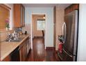 Galley kitchen with stainless steel appliances and wooden cabinets at 2356 S Franklin St, Denver, CO 80210