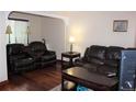 Inviting living room with plush, dark couches and wood flooring at 2356 S Franklin St, Denver, CO 80210