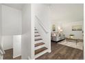 Inviting foyer with wood floors, staircase, and a glimpse into the cozy living room at 5193 Zinnia St, Arvada, CO 80002