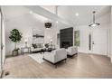 Bright and modern living room boasts vaulted ceilings, statement lighting, sleek fireplace, and comfortable seating at 5401 E Dakota Ave # 22, Denver, CO 80246