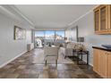 Bright living room featuring tile flooring, a sliding glass door with balcony, and modern furniture at 909 N Logan St # 11A, Denver, CO 80203