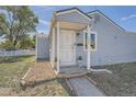 Front door entrance with small porch at 1289 Newark St, Aurora, CO 80010