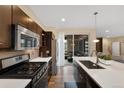 Well-equipped kitchen with stainless steel appliances, gas range, a large island with a sink, and backyard patio at 9624 Dunning Cir, Highlands Ranch, CO 80126