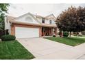 Beautiful two-story home with brick facade, large driveway, and well-maintained landscaping at 17530 E Caspian Pl, Aurora, CO 80013