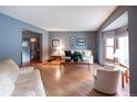 Bright living room featuring hardwood floors, a large window, and comfortable seating at 17530 E Caspian Pl, Aurora, CO 80013