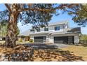 Inviting two-story home with a three-car garage, mature tree and meticulously maintained landscaping at 2999 Olympia Cir, Evergreen, CO 80439