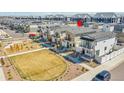 Aerial view of a new home, located near a playground with a grassy common area at 18284 E 49Th Pl, Denver, CO 80249