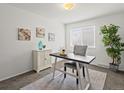 Inviting home office with light gray carpet, modern desk, white cabinet, and natural light at 7700 W Glasgow Place # 15A, Littleton, CO 80128