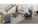 Cozy living space with bar stool seating, soft rug, and view into kitchen area at 7700 W Glasgow Place # 15A, Littleton, CO 80128