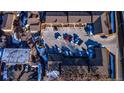 An aerial view showcasing ample parking space and snow-covered landscaping of the townhome complex at 4665 W 6Th Ave # 21, Denver, CO 80204