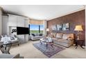 Well-appointed living room features stylish decor, comfortable seating, and large windows offering natural light at 8100 E Union Ave # 712, Denver, CO 80237
