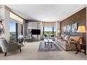 Elegant living room with neutral tones, comfortable seating, and expansive windows offering scenic views at 8100 E Union Ave # 712, Denver, CO 80237
