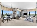 Bright living room boasts expansive windows, stylish furnishings, and an open concept perfect for modern living at 8100 E Union Ave # 712, Denver, CO 80237