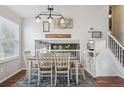 Dining room with a dining table, decorative lighting, decor, and hardwood flooring at 11072 Quail Ct, Parker, CO 80134