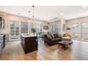 Bright open-concept living room featuring hardwood floors and large windows at 2695 W Grand Ave, Littleton, CO 80123