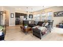 Open-concept living room with modern decor, hardwood floors, and lots of natural light at 2695 W Grand Ave, Littleton, CO 80123