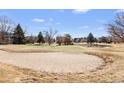 Beautiful golf course view with sand trap, green, mature trees, and water feature in the background at 3082 S Wheeling Way # 106, Aurora, CO 80014