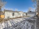 Property with a house, detached garage, and driveway at 846 S Sheridan Blvd, Denver, CO 80226