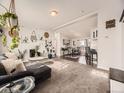 Sunlit living room featuring plush seating, stylish decor, and an open layout into the dining area at 846 S Sheridan Blvd, Denver, CO 80226