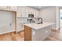 Stylish kitchen features a large island, stainless appliances, and chic white cabinets for ample storage at 6882 Oak Canyon Cir, Castle Pines, CO 80108