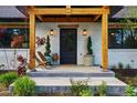 Inviting front porch with wood columns, seating, stylish lighting, and decorative plants at 1801 Redwood Ave, Boulder, CO 80304