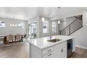 Open-concept kitchen with a center island, stainless steel appliances, and seamless access to the dining area at 7040 Homeplace St, Castle Rock, CO 80108