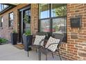 Inviting front porch features comfortable seating, decorative pillows, and a welcoming entrance at 2480 Quitman St, Denver, CO 80212