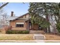 Brick home with classic architectural details and mature landscaping creating a cozy curb appeal at 925 Steele St, Denver, CO 80206