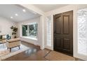 Bright entryway featuring a sleek front door, hardwood floors and a bay window at 6581 E Heritage Pl, Englewood, CO 80111