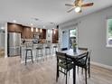 Eat-in kitchen with stainless steel appliances, modern countertops, light backsplash, and seating at peninsula at 9423 Brentwood St, Broomfield, CO 80021