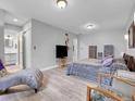 Spacious main bedroom with ensuite bathroom featuring a soft color palette and hardwood flooring at 9423 Brentwood St, Broomfield, CO 80021