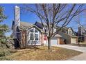 Charming two-story home featuring a well-maintained front yard and a gray painted facade and attached two-car garage at 176 S Pembrook St, Castle Rock, CO 80104