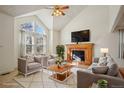 Inviting living room featuring vaulted ceilings and a cozy fireplace, bathed in natural light at 176 S Pembrook St, Castle Rock, CO 80104
